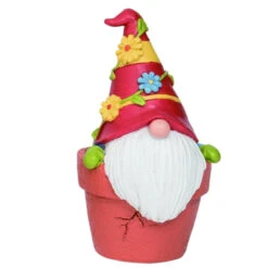 Gnome Sitting In A Flower Pot Wearing A Hat Covered With Flowers