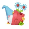 Gnome Sitting In A Flower Pot Holding A Blue Flower